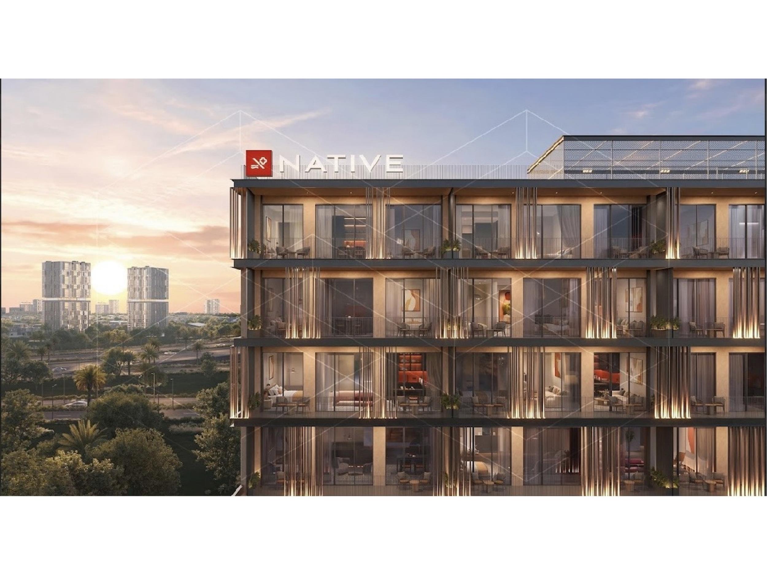 Native Haus illuminated facade with landscaped surroundings