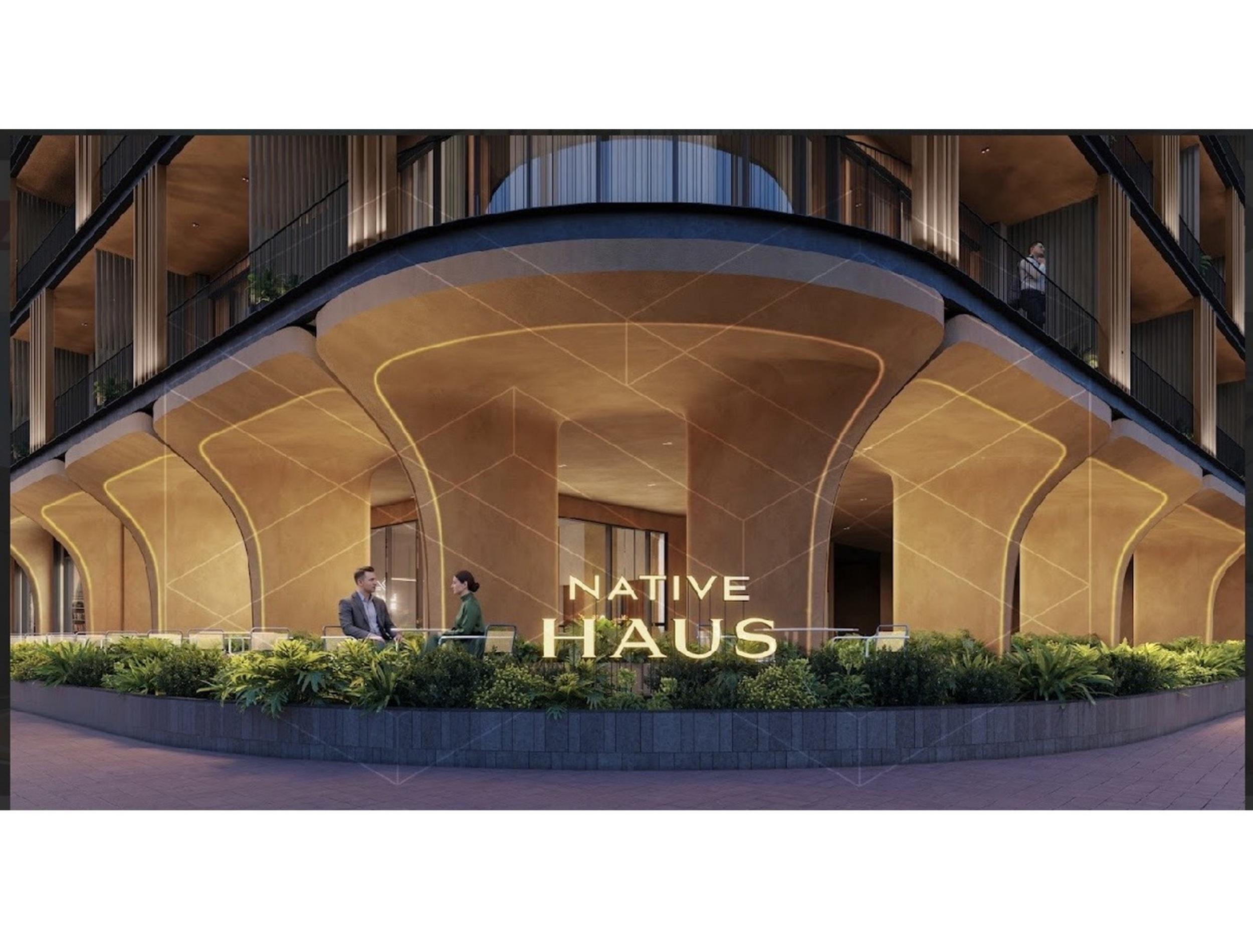 Native Haus arched entrance lit at night